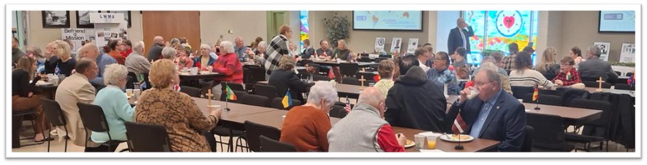 Bethany congregation members sharing a fellowship meal together at long tables